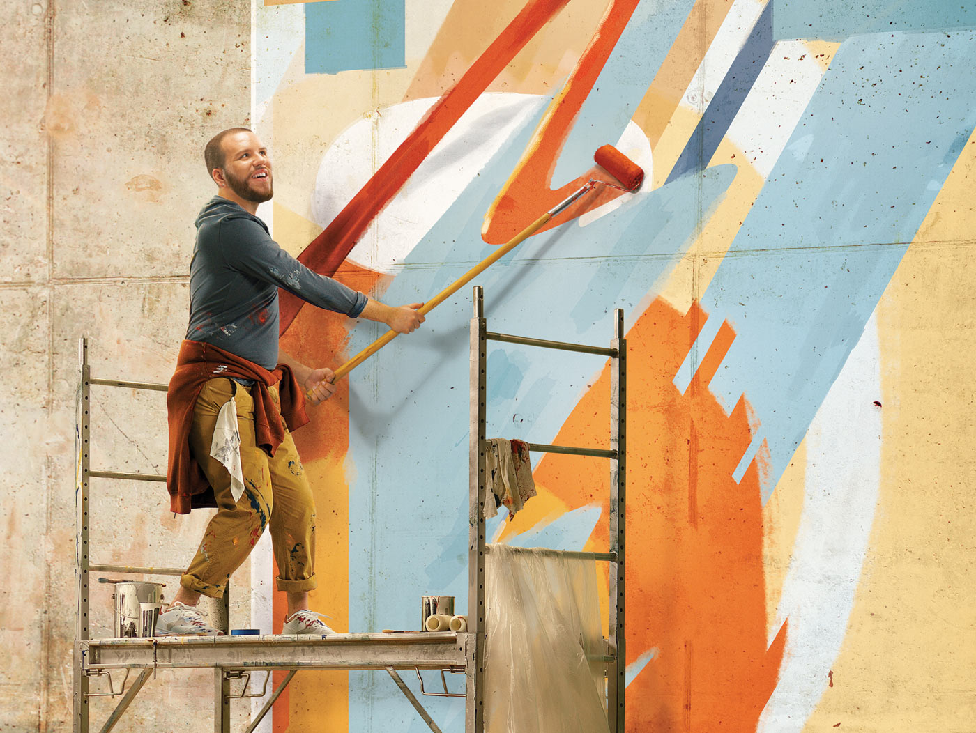 Man painting a large wall